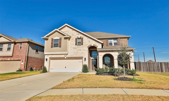 view of front of home with a garage and a front lawn