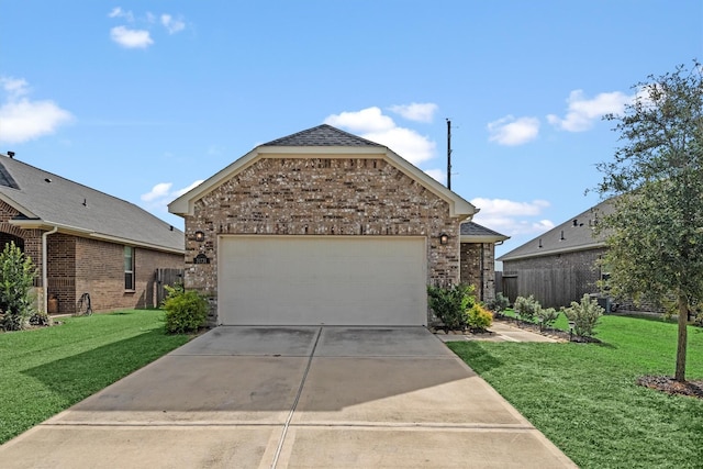 view of front of property featuring a front yard and a garage