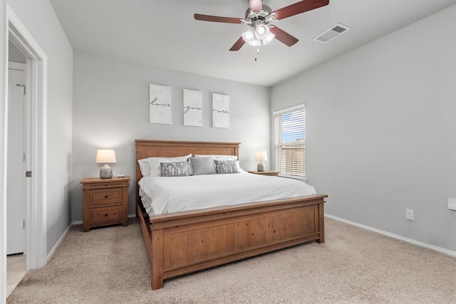 bedroom with ceiling fan and light carpet