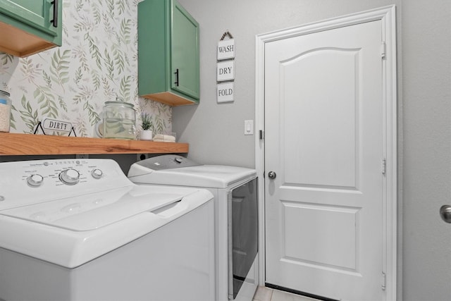 laundry room featuring cabinets and washer and dryer