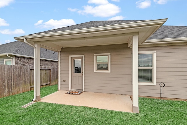 property entrance with a yard and a patio