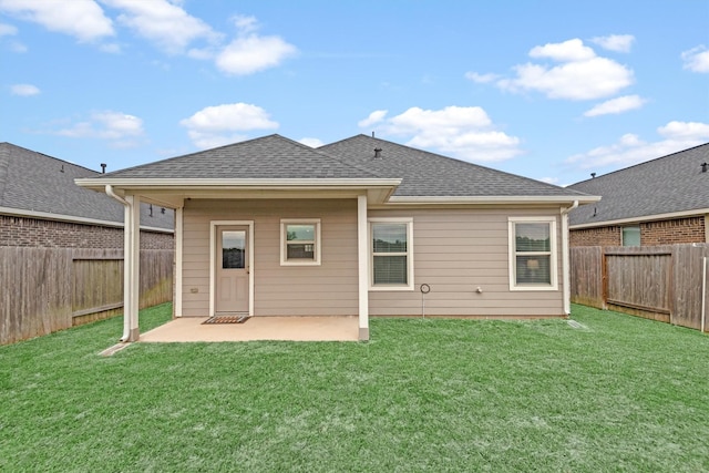 back of house with a yard and a patio area