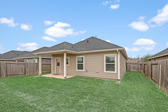 back of house featuring a patio area and a yard