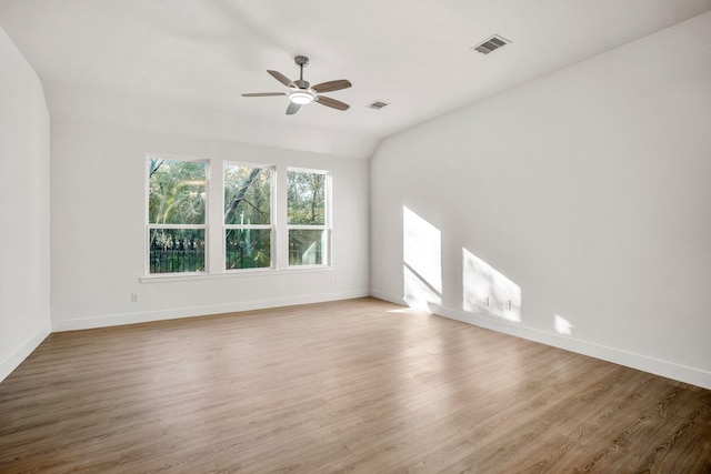 unfurnished room with ceiling fan, light hardwood / wood-style floors, and lofted ceiling