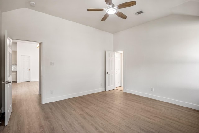 spare room with ceiling fan, hardwood / wood-style floors, and lofted ceiling