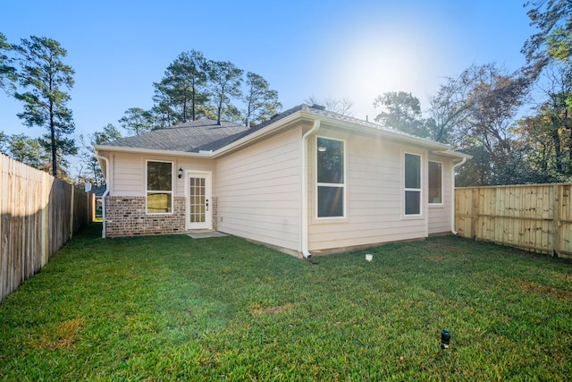 back of property featuring a lawn