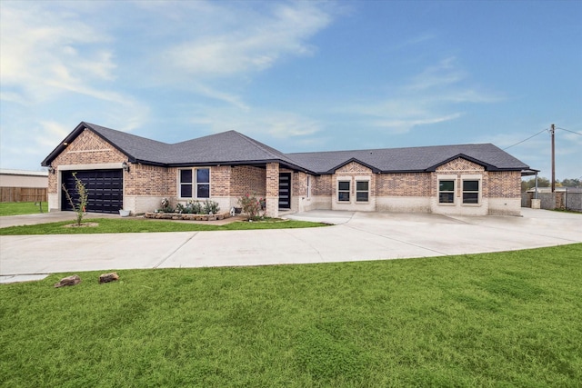 view of front of home with a front yard and a garage