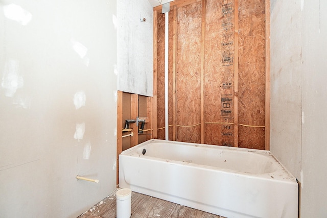 bathroom featuring wood-type flooring and a washtub