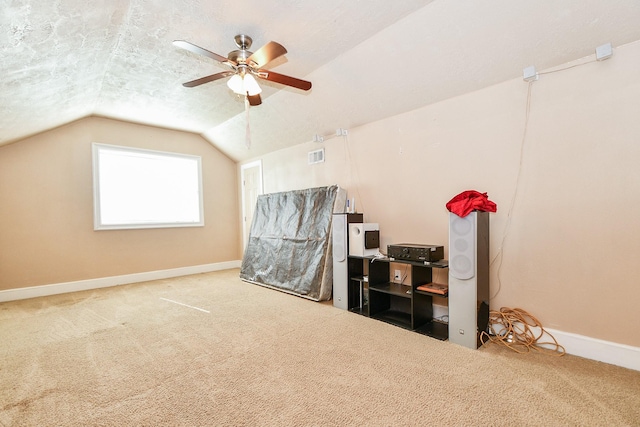 bonus room with ceiling fan, lofted ceiling, carpet floors, and a textured ceiling