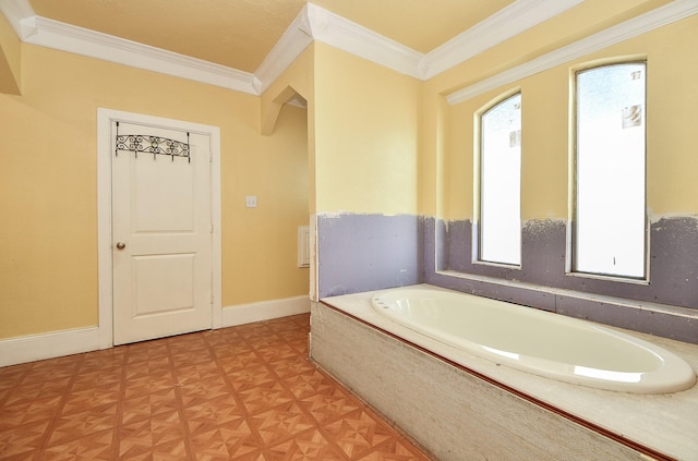 bathroom with crown molding, parquet flooring, and tiled bath