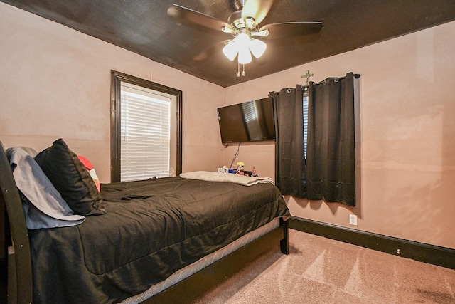 bedroom featuring ceiling fan and carpet