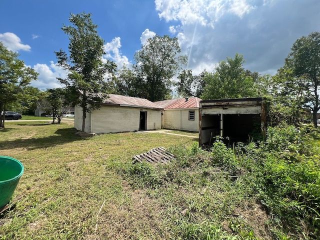 rear view of property with a yard