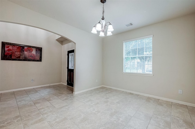 empty room featuring an inviting chandelier