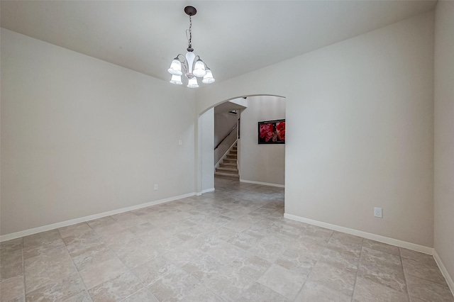 unfurnished room with an inviting chandelier