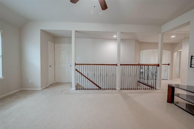 spare room featuring ceiling fan and light colored carpet