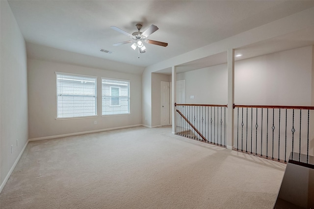 unfurnished room featuring ceiling fan and light carpet