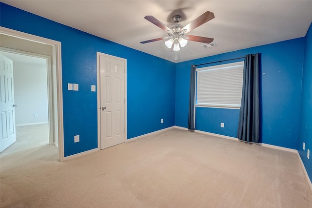 unfurnished bedroom featuring light carpet and ceiling fan