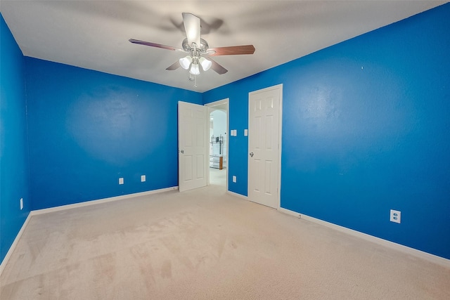 unfurnished room featuring light carpet and ceiling fan