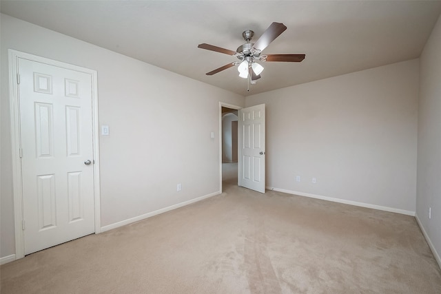 unfurnished room with ceiling fan and light colored carpet