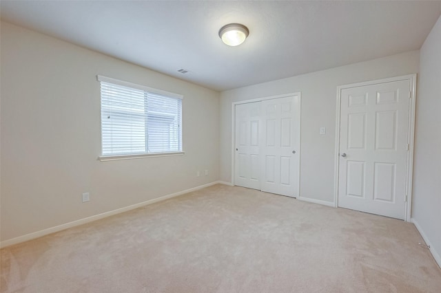 unfurnished bedroom with light colored carpet