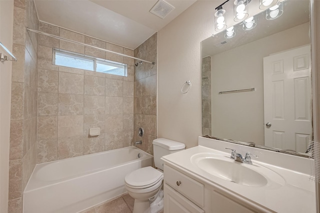 full bathroom featuring tile patterned flooring, vanity, tiled shower / bath combo, and toilet