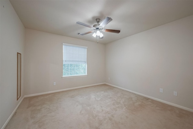 spare room with light carpet and ceiling fan