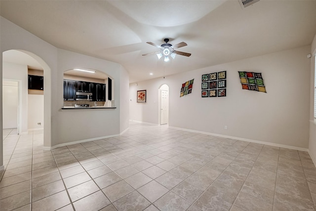 spare room with tile patterned flooring and ceiling fan