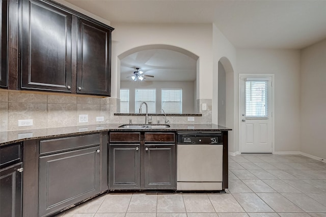 kitchen featuring dishwasher, sink, ceiling fan, dark brown cabinets, and light tile patterned flooring