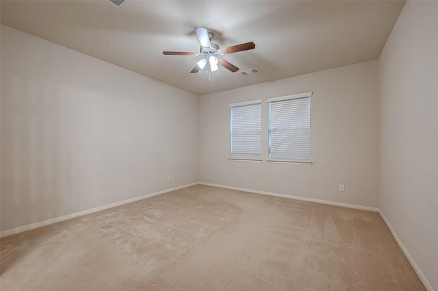 carpeted empty room featuring ceiling fan