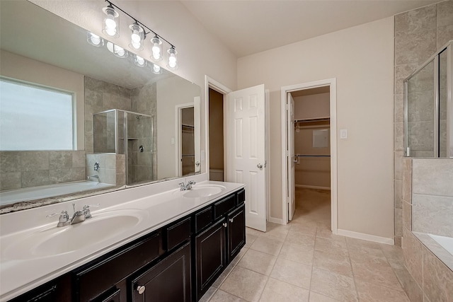 bathroom with plus walk in shower, vanity, and tile patterned flooring