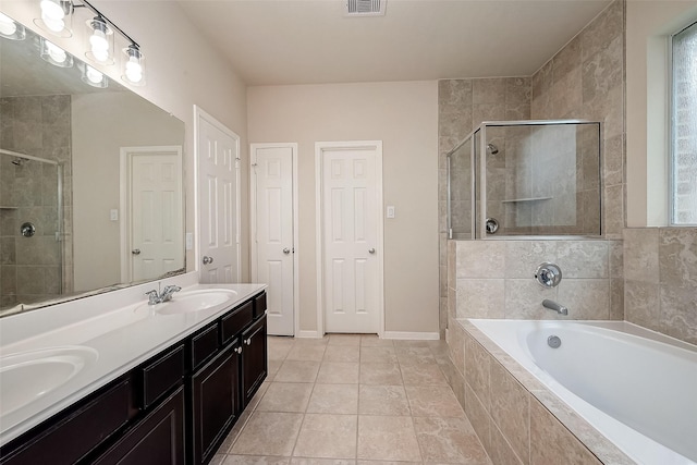 bathroom with tile patterned flooring, vanity, and independent shower and bath