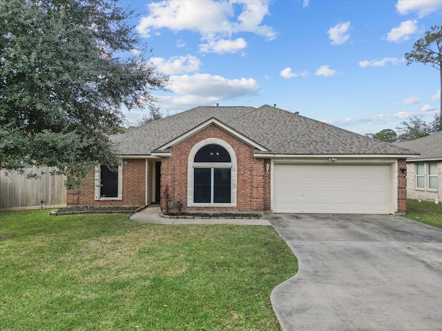 ranch-style home with a garage and a front yard