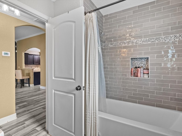 bathroom with shower / tub combo, ornamental molding, and wood-type flooring