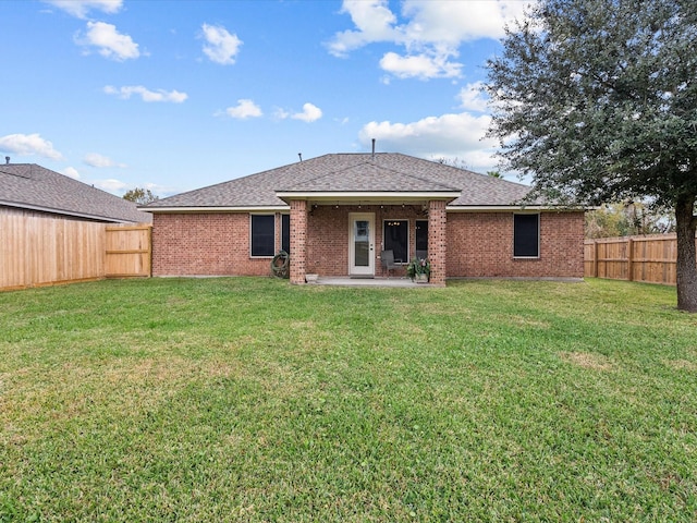 rear view of house with a yard and a patio