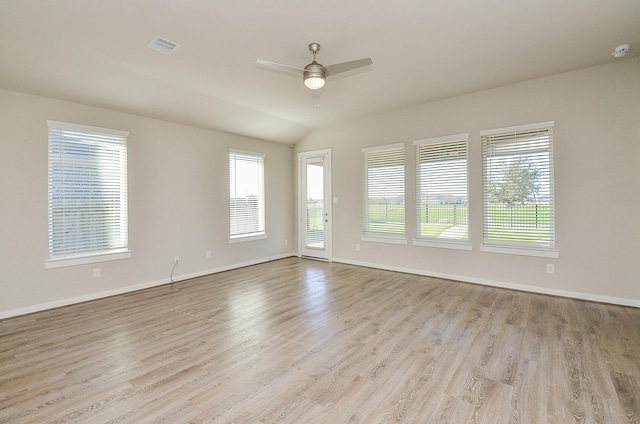 spare room featuring ceiling fan, light hardwood / wood-style floors, and lofted ceiling