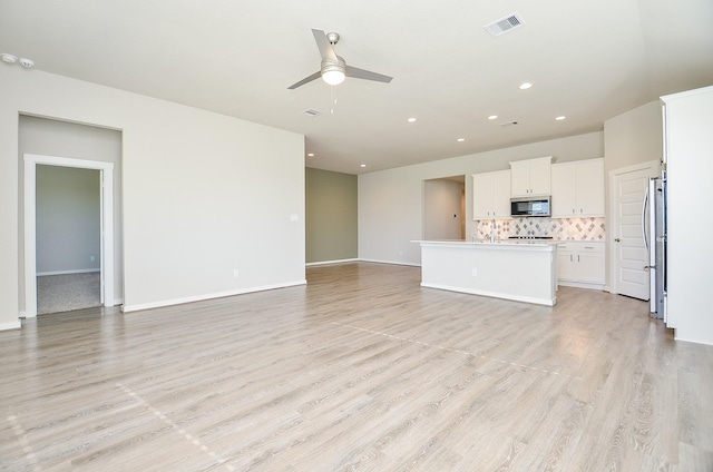 unfurnished living room featuring light hardwood / wood-style floors and ceiling fan