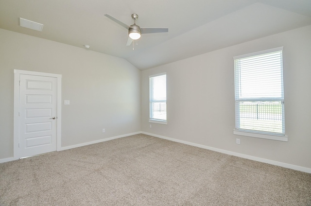 carpeted empty room with vaulted ceiling and ceiling fan