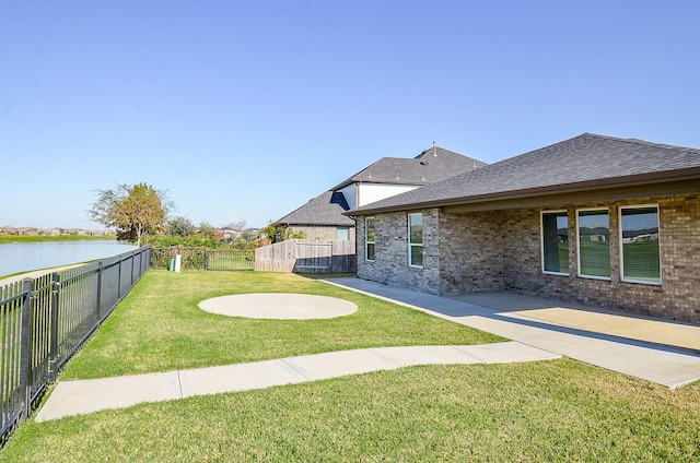 view of yard with a patio and a water view