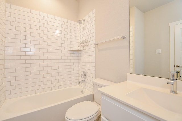 full bathroom featuring vanity, tiled shower / bath combo, and toilet