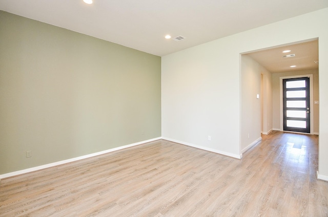 unfurnished room with light hardwood / wood-style flooring