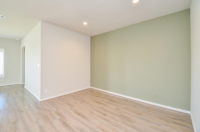 unfurnished room featuring light hardwood / wood-style flooring