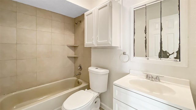 full bathroom with tiled shower / bath combo, toilet, and vanity