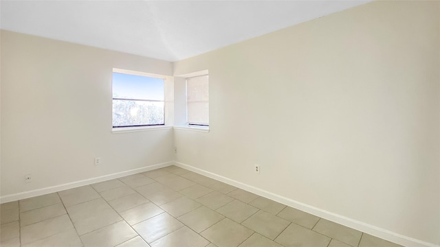 spare room with light tile patterned flooring