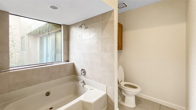 bathroom featuring tile patterned flooring, shower / bath combination, and toilet