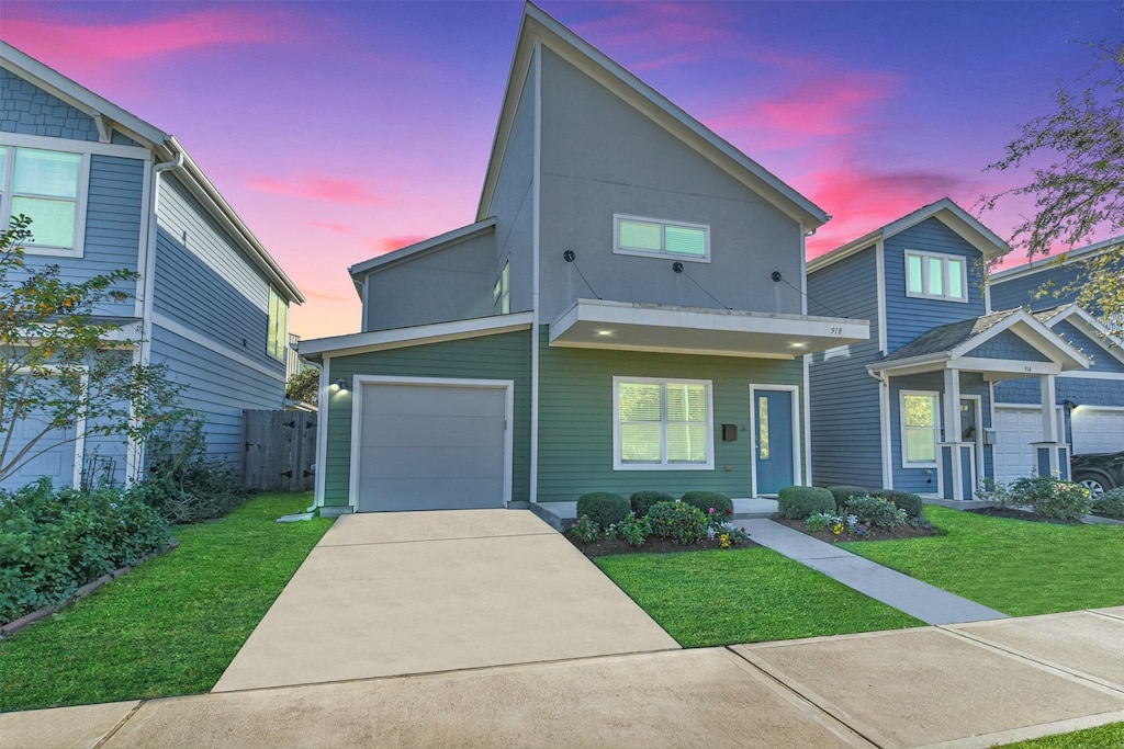 view of front of house with a yard and a garage