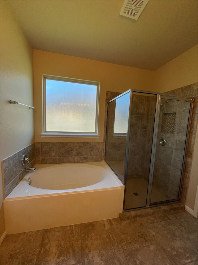 bathroom with shower with separate bathtub