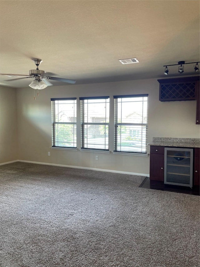 kitchen featuring carpet flooring, ceiling fan, plenty of natural light, and beverage cooler