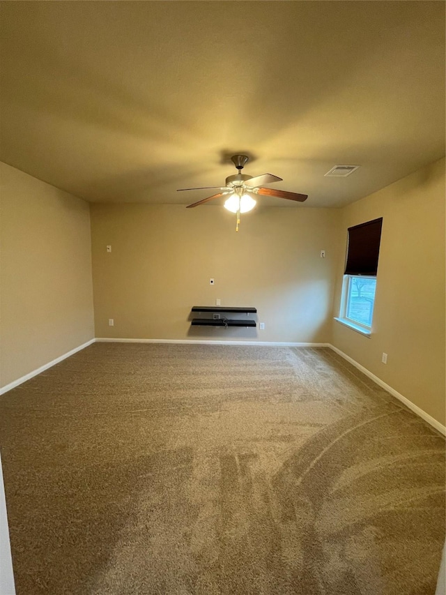 unfurnished living room featuring carpet flooring and ceiling fan