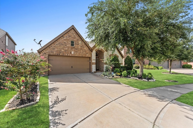 view of front of home featuring a garage and a front yard