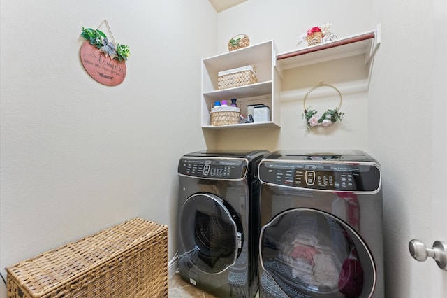 clothes washing area featuring washer and dryer